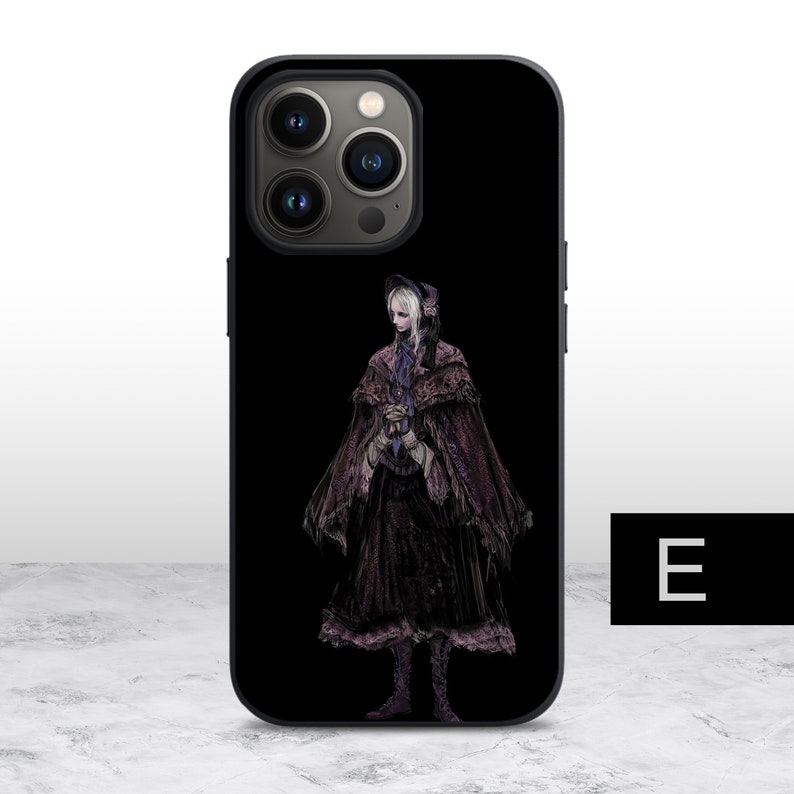 May include: Black phone case with a design of a woman in a long, dark dress and a hood. The woman is standing on a black background. The phone case has a camera bump with three lenses.