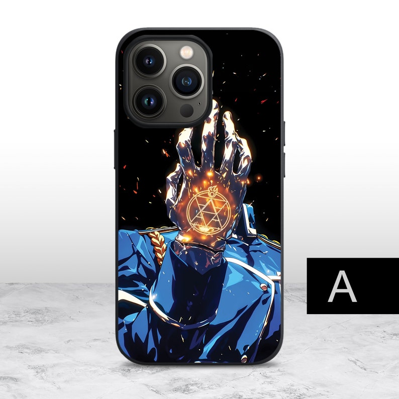 May include: Black phone case with a detailed illustration of a character from the anime Fullmetal Alchemist. The character's hand is raised with a glowing symbol on the palm. The background is black with a starry pattern.