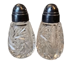 Vintage set of 3&quot; cut glass salt and pepper shakers with metal lids.