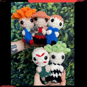 May include: Five crocheted plush toys, each representing a different horror movie character. The characters are:  a red-haired boy, a man with a hockey mask, a man with a blue jumpsuit, a man with a green and white striped shirt, and a man with a black and white striped shirt. The text "PATTERN RELEASE Mini Assailants" is at the top of the image. The text "@tinasart66" is at the bottom of the image.