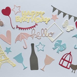 May include: A collection of paper cut-outs in various colours and shapes, including hearts, butterflies, stars, umbrellas, a bottle, wine glasses, a birdcage, a bird, an Eiffel Tower, a bow, a banner that says "Happy Birthday", and a banner that says "hello".