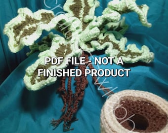 May include: Crochet pattern for a green and brown leafy plant with a brown root system and a beige pot. The text "PDF FILE - NOT A FINISHED PRODUCT" is visible on the image.