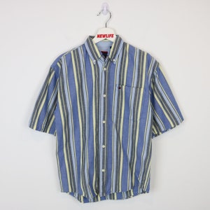 May include: A blue and yellow striped short-sleeved button-down shirt with a small pocket on the left chest.