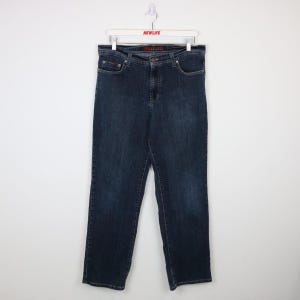 May include: Dark blue denim jeans with a red "New Life" label on the back waistband.