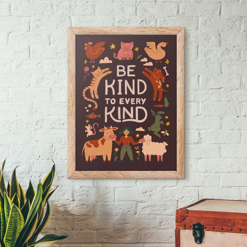 May include: A framed poster with a brown background and the words "BE KIND TO EVERY KIND" in white. The poster features illustrations of various animals, including a chicken, pig, cat, dog, cow, and sheep, in a whimsical style.