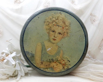 Beautiful French large round tin with young girl holding flowers from the 1930s
