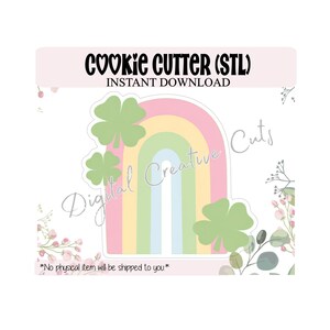 May include: A cookie cutter design with a rainbow and shamrocks. The text "COOKIE CUTTER (STL) INSTANT DOWNLOAD" is at the top. The words "Digital Creative Cuts" are also visible. The bottom text reads "*No physical item will be shipped to you*".