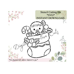 May include: Black and white stencil design of a gingerbread man in a Christmas stocking, with a candy cane and holly. Text reads "Stencil Cutting file *SVG* INSTANT DOWNLOAD" and "Digital Creative Cuts". The bottom text says "*No physical item will be shipped to you*".