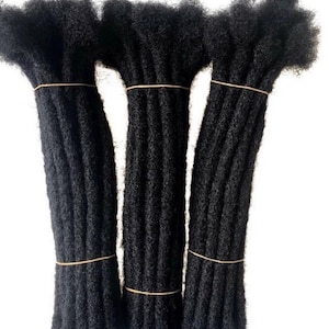 May include: Three bundles of black synthetic dreadlocks hair extensions. Each bundle is tied together with a rubber band.