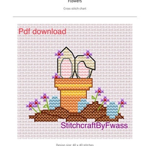 May include: Cross stitch pattern of two pink Easter eggs in a brown pot with purple flowers and blue eggs on the ground. The pattern is 40 x 40 stitches. StitchcraftByFwass.