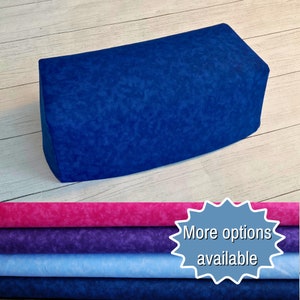 May include: A blue wedge pillow with a marbled pattern. More options are available in pink, purple, light blue, and dark blue.