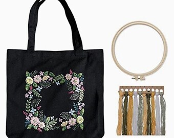 Complete embroidery kit includes a pre-printed black canvas floral embroidery bag + instructions + hoop + threads + needles