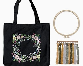 Complete embroidery kit includes a pre-printed black canvas floral embroidery bag + instructions + hoop + threads + needles