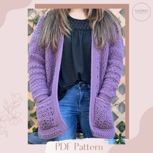 May include: A purple crochet cardigan with pockets and a PDF pattern download available. The cardigan is shown being worn with a black top and blue jeans.