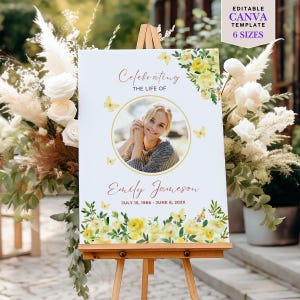 May include: A white sign on a wooden easel, with a photo of a woman in a gold circle, and text that reads "Celebrating the Life of Emily Jameson." The sign is decorated with yellow floral and butterfly accents. The text "EDITABLE CANVA TEMPLATE 6 SIZES" is in the upper right corner.