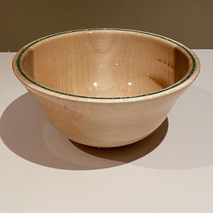 Maple bowl with a green glitter colored epoxy accented rim