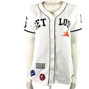 May include: White baseball jersey with black trim and the words "GET LOST" in black block letters. The jersey has several patches and a small orange graphic. The jersey is button-down and short-sleeved.