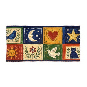 May include: A rectangular textile featuring a repeating pattern of folk art motifs. The design includes a blue bird, crescent moon, red heart, yellow star, sun with a face, flower, dove, and a black cat. The artwork is set against a dark blue background.