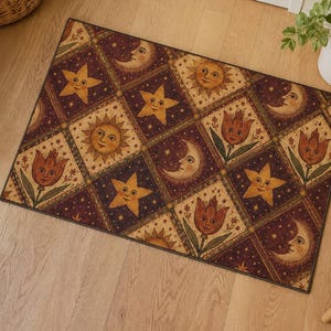 May include: Rectangular doormat with a repeating pattern of celestial and floral designs. The design features smiling suns, crescent moons, stars, and tulips in a grid pattern. The color palette includes burgundy, tan, and gold.