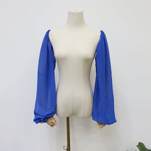May include: A pair of blue sheer sleeves with a gathered puff at the shoulder.