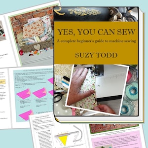 May include: A book titled "Yes, You Can Sew: A complete beginner's guide to machine sewing" by Suzy Todd. The cover features a close-up of a sewing machine and a hand guiding fabric through the machine. The book is surrounded by colourful fabric scraps and sewing supplies.