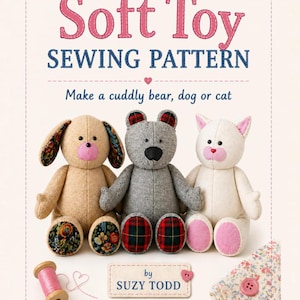 May include: A soft toy sewing pattern by Suzy Todd featuring text Soft Toy SEWING PATTERN Make a cuddly bear, dog or cat. The image displays three plush animals: a tan dog, a grey bear, and a white cat, alongside a spool of pink thread and buttons.