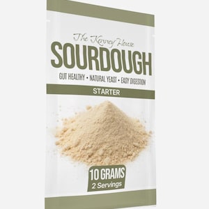 May include: A packet of sourdough starter from The Kenney House. The packet is white with a green stripe and contains 10 grams of starter, enough for 2 servings. Text on the packet reads "SOURDOUGH", "GUT HEALTHY", "NATURAL YEAST", and "EASY DIGESTION".