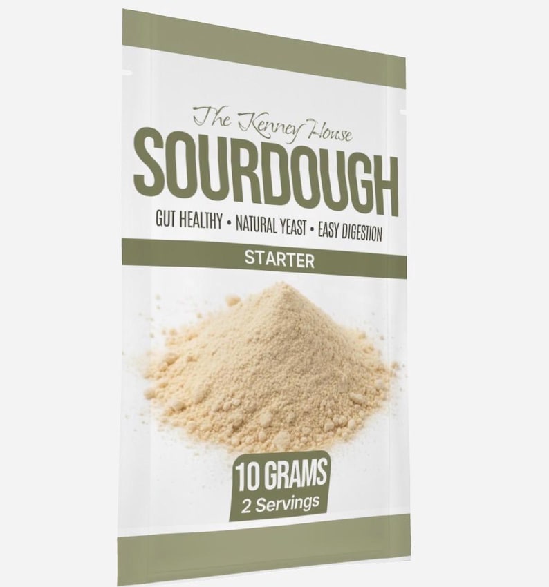 May include: A packet of sourdough starter from The Kenney House. The packet is white with a green stripe and contains 10 grams of starter, enough for 2 servings. Text on the packet reads "SOURDOUGH", "GUT HEALTHY", "NATURAL YEAST", and "EASY DIGESTION".