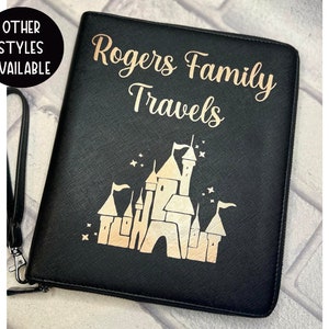 May include: Black leather travel binder with a gold glitter design of Cinderella's castle and the text "Rogers Family Travels".