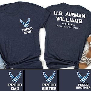 May include: A set of four navy blue t-shirts with a blue Air Force logo and text that reads "Proud Mom", "Proud Dad", "Proud Sister", and "Proud Brother". The back of one shirt has the text "U.S. Airman Williams 769 TRS/FLT 007 EAGLES".
