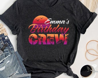 May include: A dark gray t-shirt with a sunset graphic and the text "Emma's Birthday Crew".