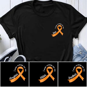 Könnte beinhalten: Ein schwarzes T-Shirt mit kurzen Ärmeln und einer orangefarbenen Awareness-Schleife auf der linken Brust. Die Schleife enthält den weißen Text "I wear orange for my son". Das Design wird auch in Varianten für Tochter, Schwester und Bruder gezeigt.