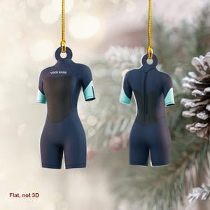 May include: A blue and black wetsuit ornament with a white "YOUR NAME" text on the front. The ornament is flat and not 3D.