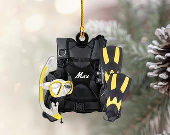 May include: A black scuba diving vest with yellow fins and a snorkel and mask. The vest has the word "Max" printed on it.