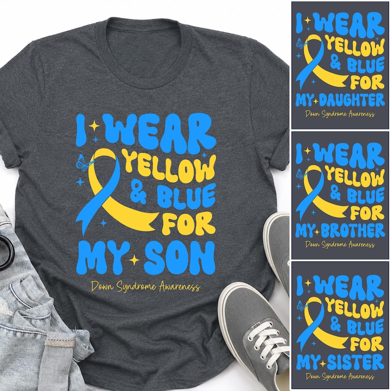 May include: A dark heather grey t-shirt featuring a yellow and blue awareness ribbon graphic with the text I WEAR YELLOW & BLUE FOR MY SON and Down Syndrome Awareness, accompanied by small star and butterfly icons printed on the front.
