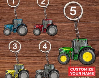 May include: Five different tractor keychains with customizable name plates. The tractors are blue, red, green, yellow, and black. The keychains are labeled with numbers 1 through 5. The text "CUSTOMIZE YOUR NAME" and "FLAT, NOT 3D" is at the bottom of the image.
