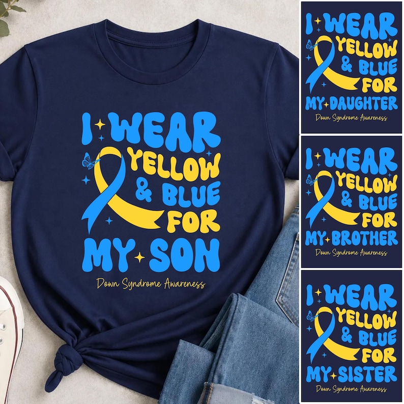 May include: A navy blue t-shirt featuring a yellow and blue awareness ribbon graphic with the text I WEAR YELLOW & BLUE FOR MY SON and Down Syndrome Awareness. The design includes small star and butterfly accents in a bold, wavy font style.