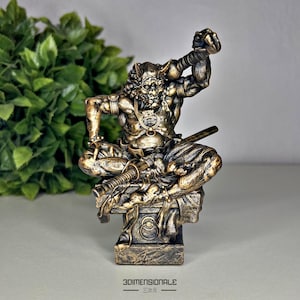 May include: A gold-colored statue of a Japanese demon with horns and a sword. The demon is sitting on a stone base with a circular design. The statue is made of resin and is approximately 10 inches tall.