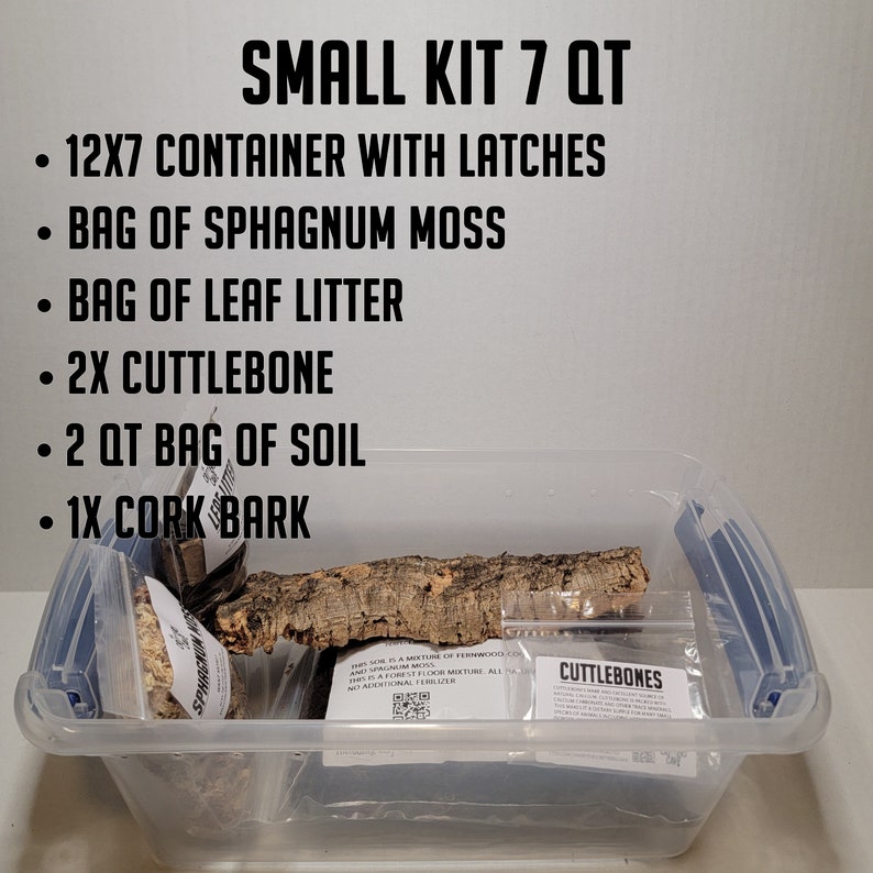May include: A clear plastic container with a blue latch, filled with a reptile habitat kit. The kit includes a bag of sphagnum moss, a bag of leaf litter, two pieces of cuttlebone, a bag of soil, and a piece of cork bark. The container is labeled "SMALL KIT 7 QT".