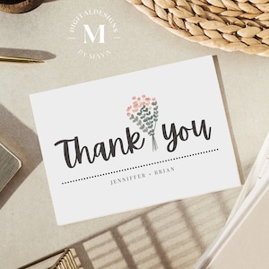 May include: A white thank you card with a floral bouquet illustration in pink and green. The text "Thank you" is in black cursive font. The names "Jennifer & Brian" are printed below the text.