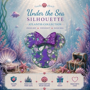 May include: A circular resin phone grip featuring a purple glitter bow and a silhouette of a mermaid. The surface is embedded with small shell and fish shapes in shades of purple and teal. Text includes Under the Sea SILHOUETTE ATLANTIS COLLECTION.