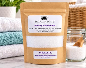 May include: A brown kraft paper pouch containing white laundry scent booster crystals. The label reads 1837 Farmer's Daughter Laundry Scent Booster, 12 oz. Handmade in Ohio, and Clotheline Fresh: a light scent of patchouli, cedarwood, and fresh linen.