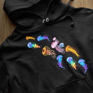 May include: Black hoodie featuring a colourful jellyfish design. The jellyfish are in various shades of blue, pink, orange and yellow.