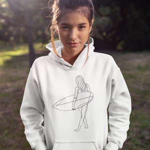 May include: White hoodie with a line drawing of a woman holding a surfboard. The drawing is in black and white.