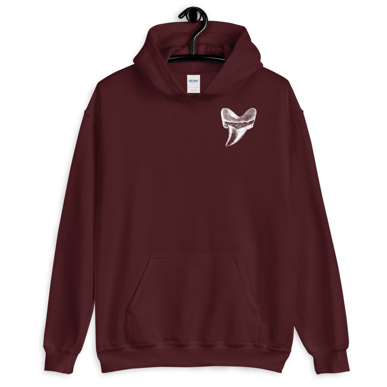 May include: Burgundy hooded sweatshirt with a white graphic of a shark tooth in the shape of a heart.