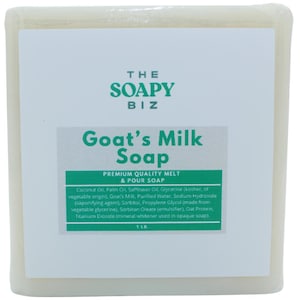 May include: A rectangular bar of goat's milk soap, wrapped in clear plastic. The label features the text "THE SOAPY BIZ" and "Goat's Milk Soap." Ingredients are listed below. The soap weighs 1 lb.