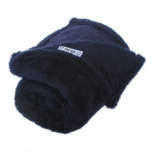 May include: A navy blue plush pet blanket rolled up with a white label that says "pet wiz" with a cat and dog icon.