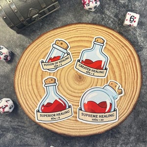 May include: Four potion stickers with cork stoppers and labels reading "Potion of Healing", "Greater Healing", "Superior Healing", and "Supreme Healing". The potions are filled with red liquid. Dice and a treasure chest are in the background.