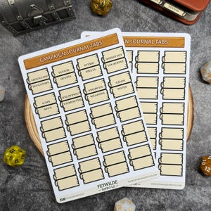 May include: Two sheets of campaign journal tabs with labels for inventory, quests, spells, and locations. The tabs are beige with brown borders and text. The text "Campaign Journal Tabs" is at the top. The brand name "Feywild Supply Co" is at the bottom.