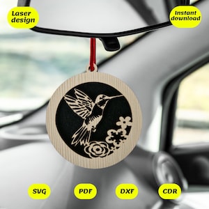 May include: A wooden car air freshener with a laser cut design of a hummingbird and flowers. The air freshener is hanging from a rearview mirror. The text "Laser design" and "Instant download" is visible in the image. The files available for download are SVG, PDF, DXF, and CDR.